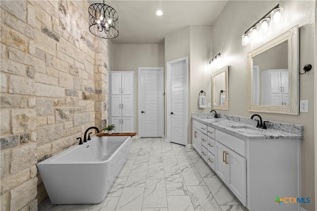 813 Reston Rd, Temple, TX 76502 - full bath with double vanity, a soaking tub, marble look tiles, and a chandelier