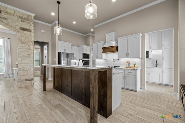 813 Reston Rd, Temple, TX 76502 - kitchen with premium range hood, appliances with stainless steel finishes, crown molding, tasteful backsplash, and light wood-type flooring