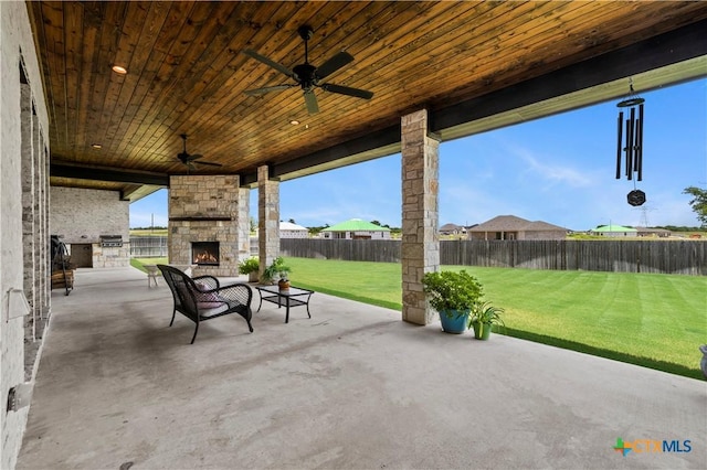 813 Reston Rd, Temple, TX 76502 - fenced backyard with an outdoor stone fireplace, a patio area, and a ceiling fan