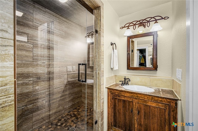 bathroom featuring an enclosed shower and sink