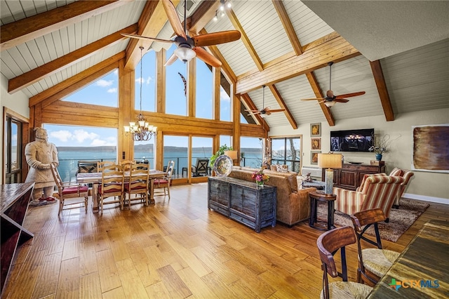 living room with ceiling fan with notable chandelier, high vaulted ceiling, beamed ceiling, and light wood-type flooring