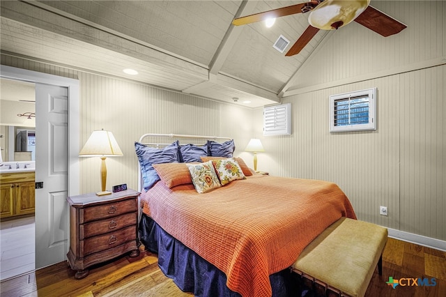 bedroom with vaulted ceiling, ceiling fan, sink, and hardwood / wood-style floors