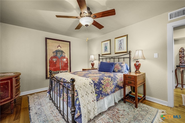 bedroom featuring hardwood / wood-style floors and ceiling fan