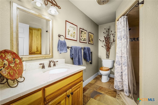 bathroom with walk in shower, vanity, and toilet