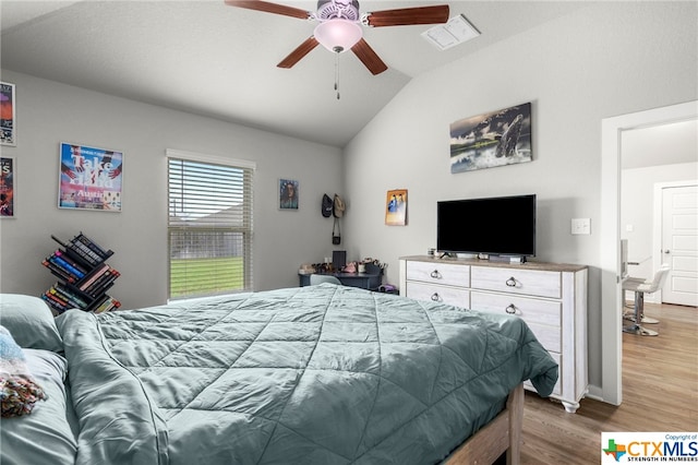 bedroom with lofted ceiling, hardwood / wood-style floors, and ceiling fan