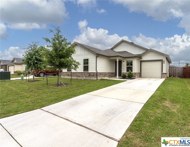 view of front of home with a garage and a front yard