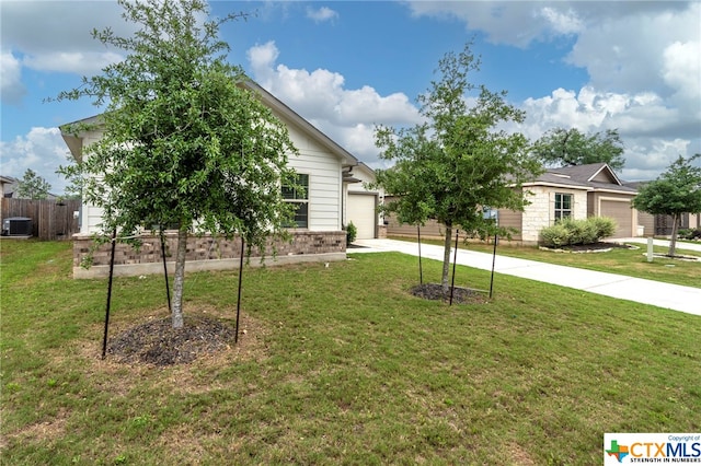 view of front facade with a front lawn and central AC