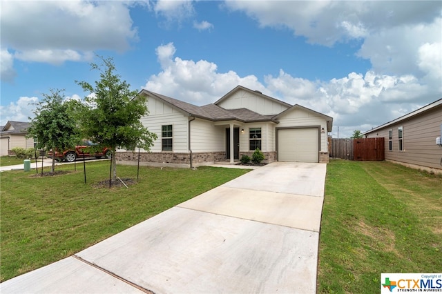 view of front of home featuring a garage and a front yard