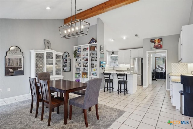 dining space with light tile patterned flooring, vaulted ceiling with beams, and a chandelier