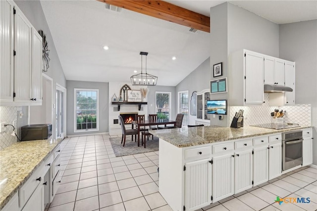 kitchen with white cabinetry, stainless steel oven, decorative light fixtures, kitchen peninsula, and light stone countertops