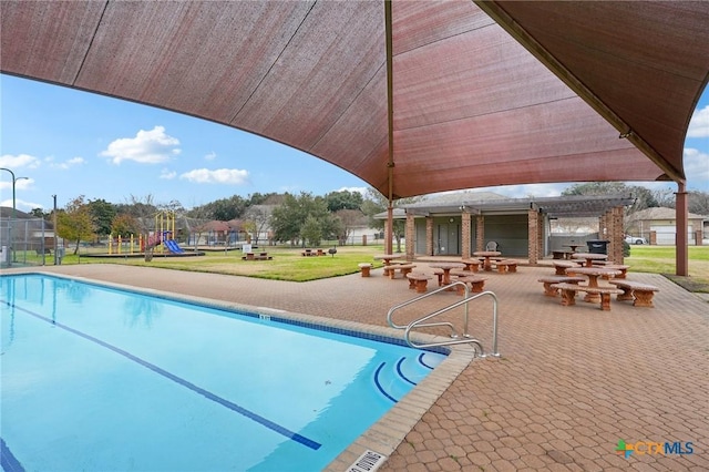 view of swimming pool featuring a playground, a lawn, a patio area, and a pergola