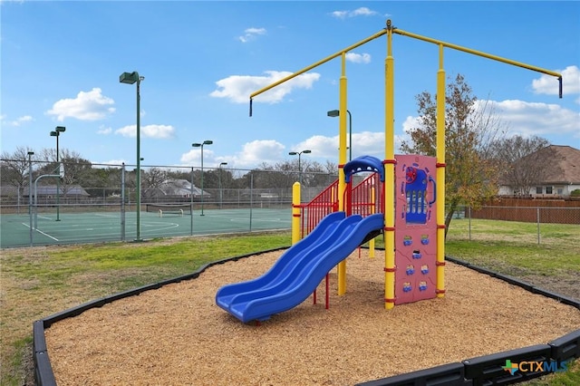 view of jungle gym with tennis court