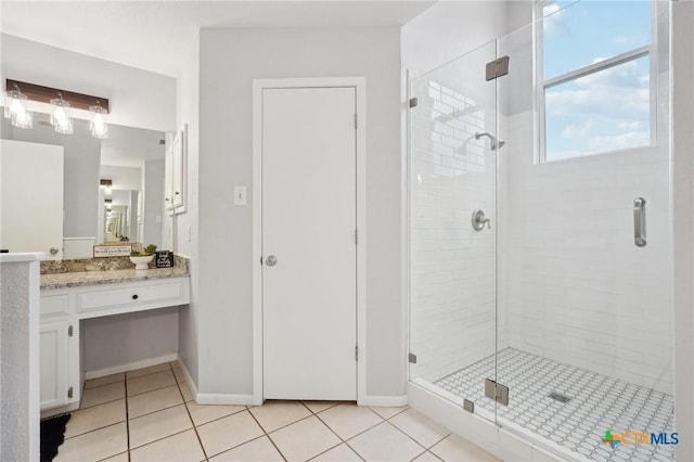 bathroom featuring vanity, an enclosed shower, and tile patterned floors