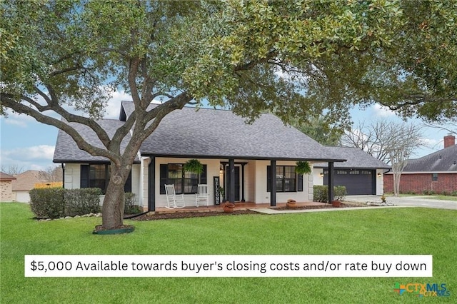 view of front of property featuring driveway, an attached garage, a porch, and a front lawn