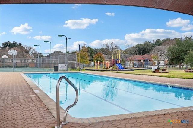 view of pool featuring a playground