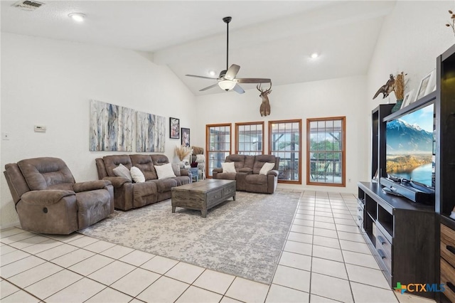 tiled living room with ceiling fan and high vaulted ceiling