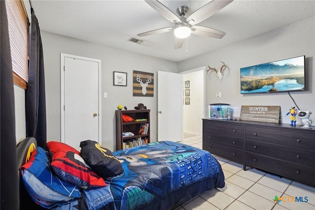 bedroom featuring light tile patterned flooring and ceiling fan