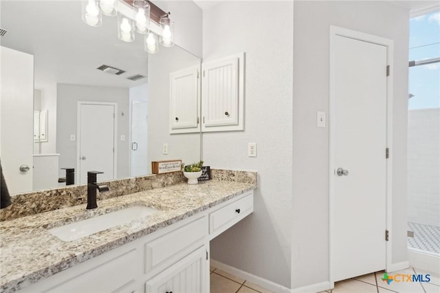 bathroom with vanity, a shower with shower door, and tile patterned flooring