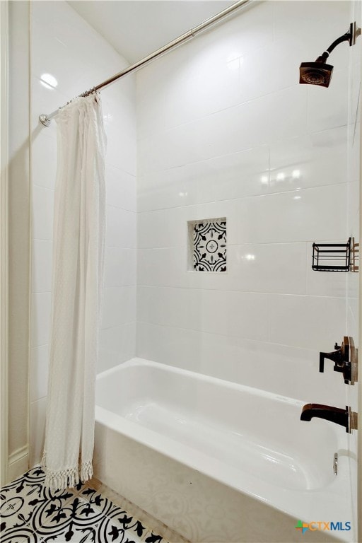 bathroom featuring tile patterned flooring and shower / bathtub combination with curtain