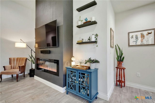 sitting room featuring light wood-type flooring