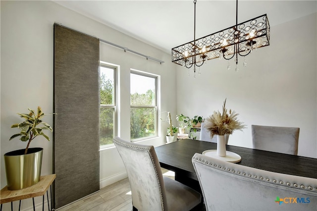 dining space featuring a chandelier and light hardwood / wood-style floors