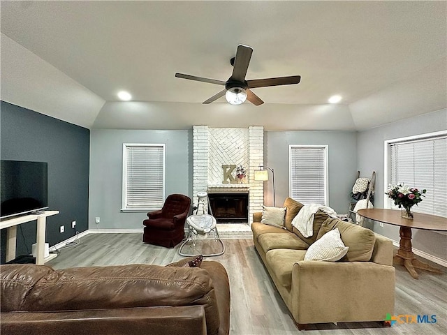 209 Roanoke Dr, Victoria, TX 77904 - living room with light wood-type flooring, ceiling fan, a brick fireplace, vaulted ceiling, and recessed lighting
