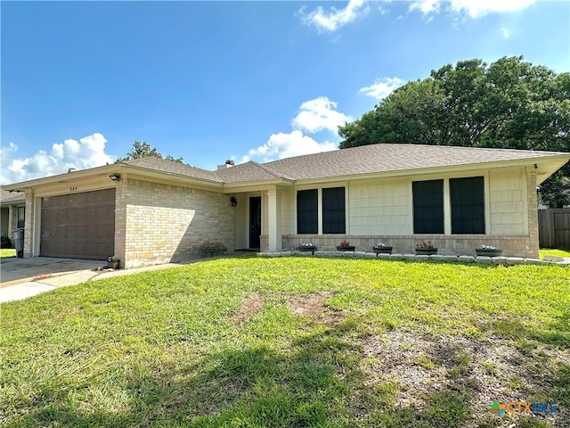 209 Roanoke Dr, Victoria, TX 77904 - ranch-style house featuring a garage, a front yard, driveway, brick siding, and a shingled roof