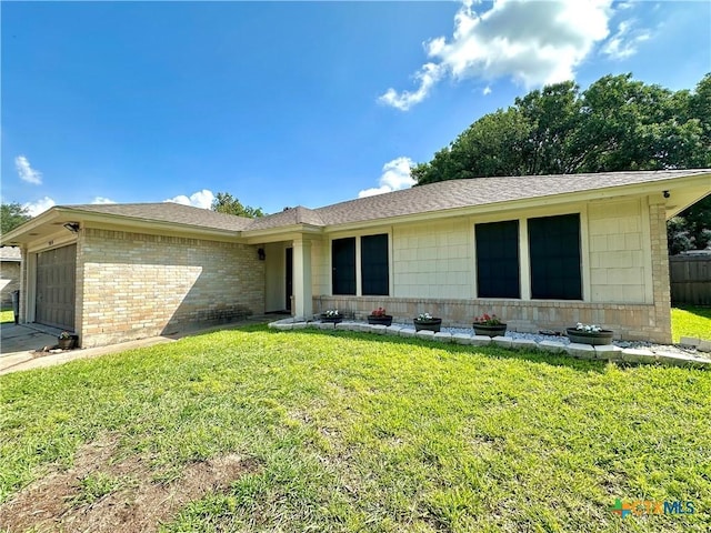 209 Roanoke Dr, Victoria, TX 77904 - ranch-style house featuring brick siding, an attached garage, a front yard, a shingled roof, and driveway