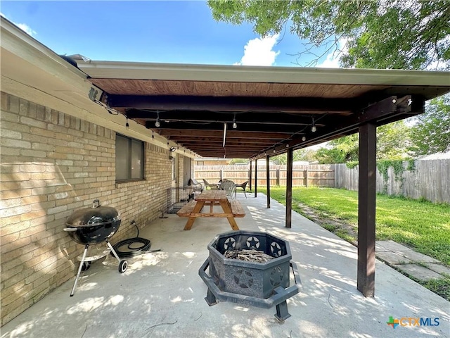 209 Roanoke Dr, Victoria, TX 77904 - fenced backyard with an outdoor fire pit, a patio, and area for grilling
