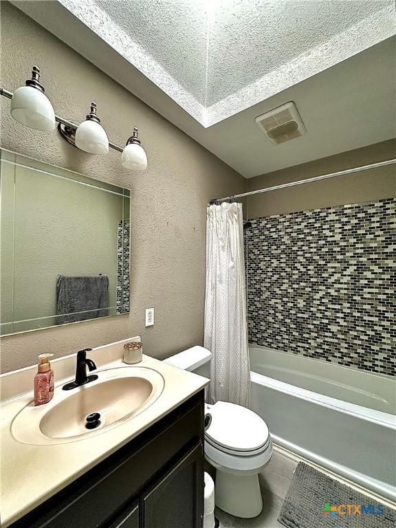 209 Roanoke Dr, Victoria, TX 77904 - full bath with vanity, shower / bath combination with curtain, and a textured wall