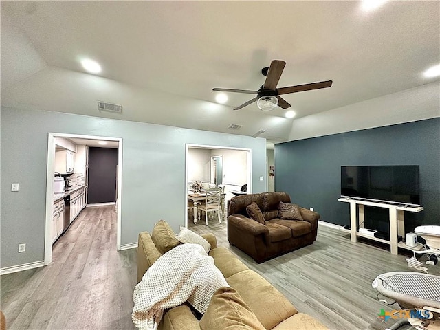 209 Roanoke Dr, Victoria, TX 77904 - living area with vaulted ceiling, ceiling fan, and wood finished floors