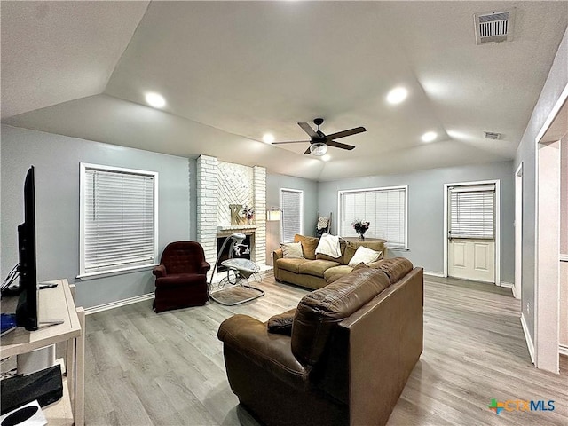209 Roanoke Dr, Victoria, TX 77904 - living area featuring lofted ceiling, ceiling fan, light wood finished floors, a brick fireplace, and recessed lighting