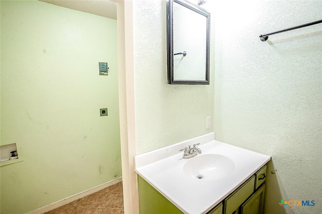 117 N 28th St, Gatesville, TX 76528 - bathroom featuring vanity, baseboards, and tile patterned floors