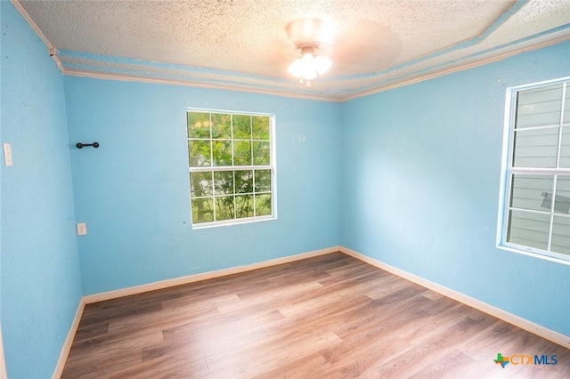 117 N 28th St, Gatesville, TX 76528 - spare room with a textured ceiling, crown molding, wood finished floors, and baseboards