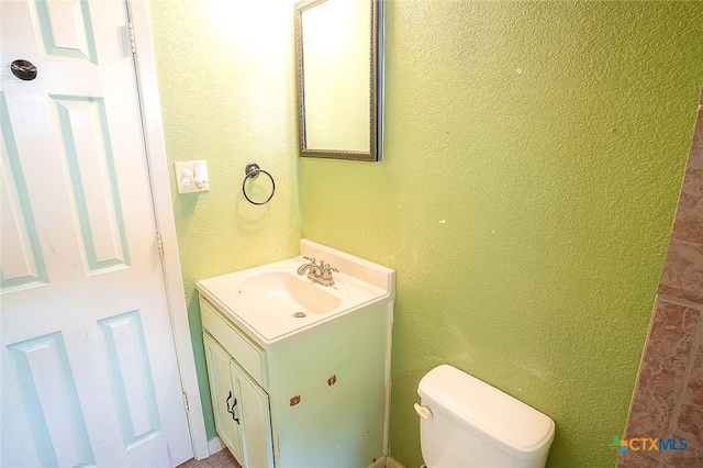 117 N 28th St, Gatesville, TX 76528 - half bath with vanity, toilet, and a textured wall