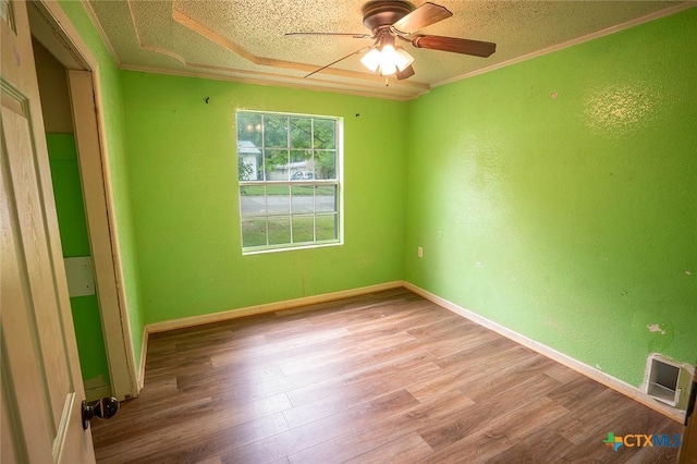 117 N 28th St, Gatesville, TX 76528 - empty room with ceiling fan, wood finished floors, crown molding, baseboards, and a textured ceiling