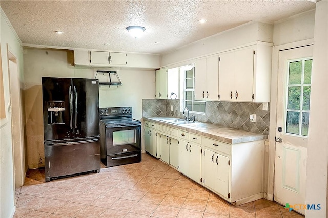 117 N 28th St, Gatesville, TX 76528 - kitchen featuring black appliances, a sink, tasteful backsplash, crown molding, and a textured ceiling