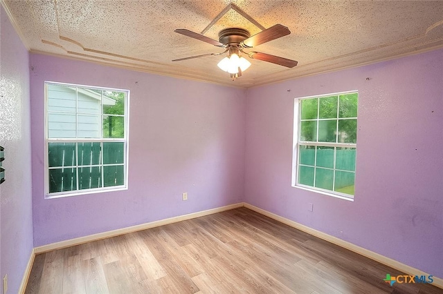 117 N 28th St, Gatesville, TX 76528 - unfurnished room with plenty of natural light, wood finished floors, ceiling fan, and baseboards