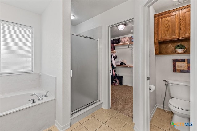 709 Aries Ave, Killeen, TX 76542 - full bath with a shower stall, a bath, tile patterned floors, a spacious closet, and plenty of natural light