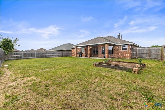 709 Aries Ave, Killeen, TX 76542 - rear view of property with brick siding, a chimney, a garden, and a patio