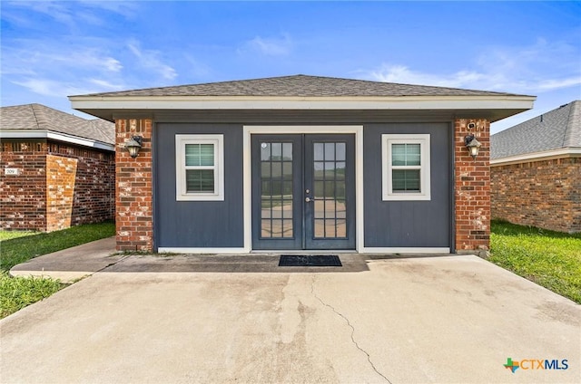 709 Aries Ave, Killeen, TX 76542 - entrance to property featuring french doors, brick siding, and roof with shingles
