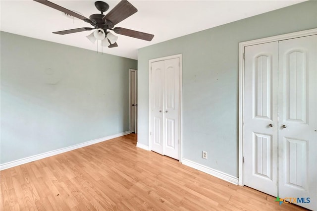 3106 Bobolink St, Victoria, TX 77901 - unfurnished bedroom featuring two closets, light wood-style floors, and ceiling fan