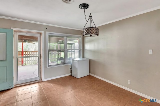 3106 Bobolink St, Victoria, TX 77901 - unfurnished dining area with crown molding and light tile patterned floors