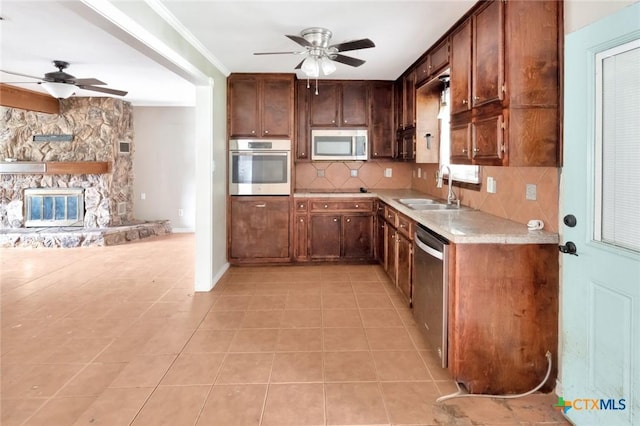 3106 Bobolink St, Victoria, TX 77901 - kitchen with stainless steel appliances, a ceiling fan, light countertops, backsplash, and crown molding
