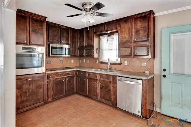 3106 Bobolink St, Victoria, TX 77901 - kitchen with appliances with stainless steel finishes, backsplash, ceiling fan, light tile patterned floors, and dark brown cabinets