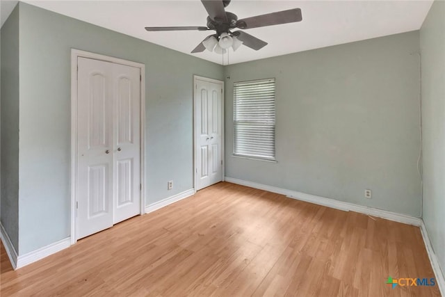 3106 Bobolink St, Victoria, TX 77901 - unfurnished bedroom with light wood-style floors, two closets, and ceiling fan