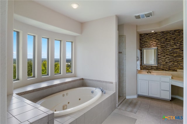 1280 Mystic Pkwy, Spring Branch, TX 78070 - bathroom with vanity, a tub with jets, a stall shower, backsplash, and tile patterned floors