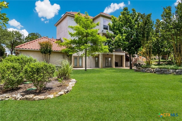 1280 Mystic Pkwy, Spring Branch, TX 78070 - rear view of property featuring a lawn, a tile roof, and stucco siding