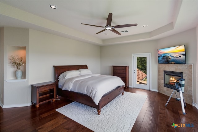1280 Mystic Pkwy, Spring Branch, TX 78070 - bedroom featuring access to outside, hardwood / wood-style floors, a tile fireplace, recessed lighting, and a raised ceiling
