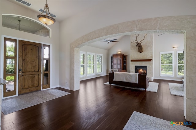 1280 Mystic Pkwy, Spring Branch, TX 78070 - foyer entrance featuring wood-type flooring, a ceiling fan, a tile fireplace, high vaulted ceiling, and arched walkways